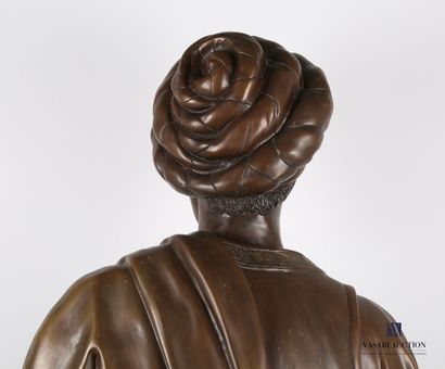null Bust in bronze with brown patina representing a Moor in ribbons resting on a...