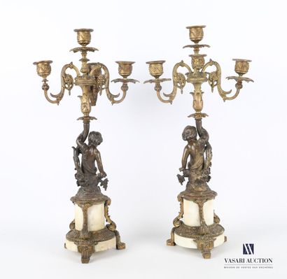 null Pair of bronze candelabras with double patinas, the shaft featuring a putto...