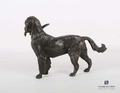 null Bronze subject with brown patina representing a hunting dog holding a duck in...
