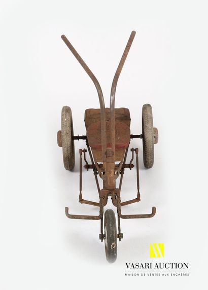 null Tricycle in sheet metal, the saddle lacquered red and the frame marked "Cyclo...