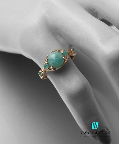 null A vermeil ring set in its center with a cabochon emerald in a navette pattern...