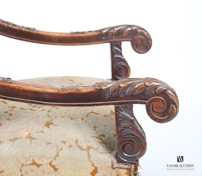 null Armchair in molded and carved natural wood, the rectangular back, the armrests...