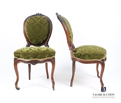 null Pair of chairs in molded and carved rosewood, the slightly curved medallion...