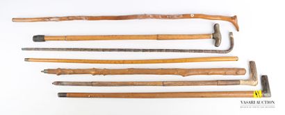 null Lot of seven canes, two with square pommels, one with a foot, one with an opera...