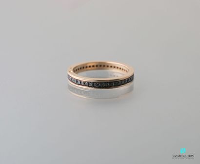 null Wedding ring in pink gold 750 thousandth set with small black diamonds of approximately...