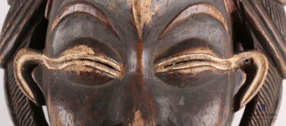 null PUNU - GABON

Black female mask in carved wood with patina and pigment, the...