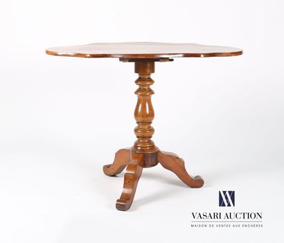 null Pedestal table in molded walnut, the tilting top of violin shape rests on a...
