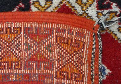 null NORTH AFRICA

Wool carpet decorated with three rhombus medallions on black background,...