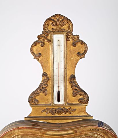 null Barometer/thermometer in wood and stucco molded and gilded, the pediment hemmed...