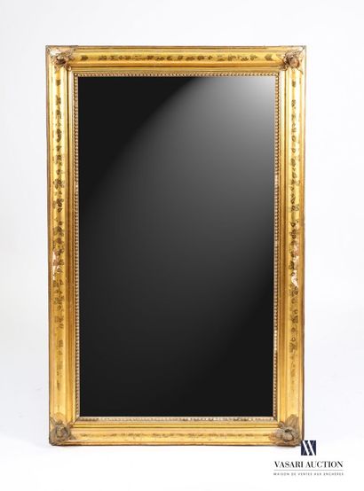 null Wooden mirror and stucco molded, carved and gilded with flowers in reparure....