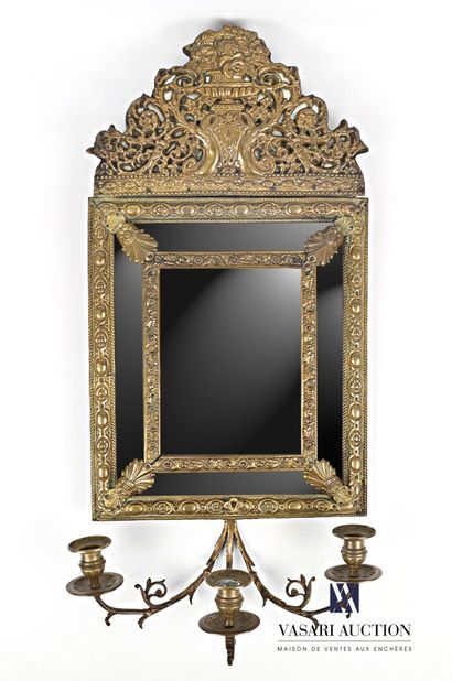 null Rectangular mirror with parecloses in embossed brass, the beveled glass hemmed...