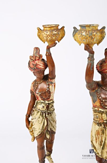 null Pair of candlesticks in regula with polychrome patina representing two slaves...