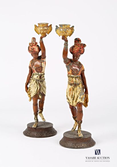 null Pair of candlesticks in regula with polychrome patina representing two slaves...