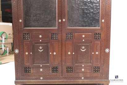 null Showcase in natural wood molded and carved with scrolls and hexagrams and octagrams...
