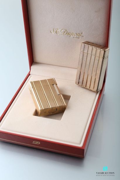null ST Dupont, two gold-plated lighters, grooved and guilloche decoration, one in...