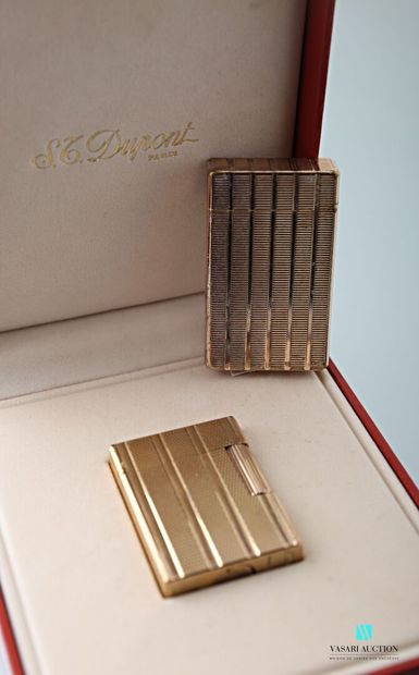 null ST Dupont, two gold-plated lighters, grooved and guilloche decoration, one in...