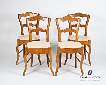 null Suite of four chairs in natural wood, the three-lobed back presents in its center...