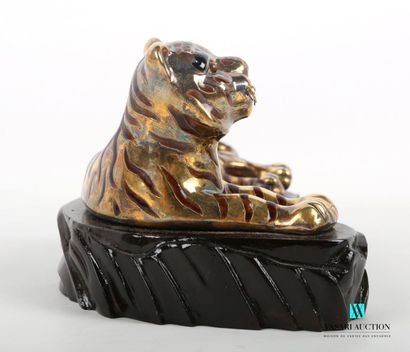 null CHINA
Gilt and enamel subject representing a tiger lying on a wooden base. 
Marked...