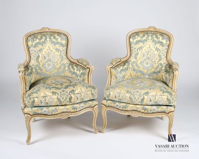 null Pair of bergères in molded and carved natural wood, lacquered cream, the backrest...