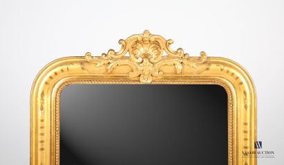 null Wooden mirror and stucco molded, carved and gilded, the entablature decorated...