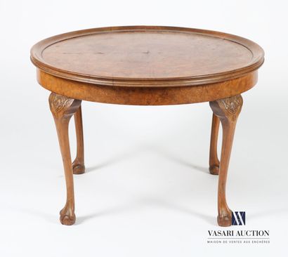 null Pedestal table in walnut and walnut veneer, the round top rests on four cambered...