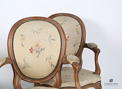null Suite of four armchairs in molded natural wood, the medallion back slightly...