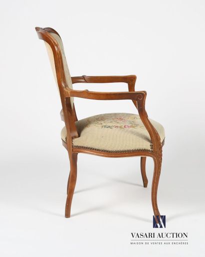 null Armchair in natural wood molded and carved, the back said in cabriolet is decorated...
