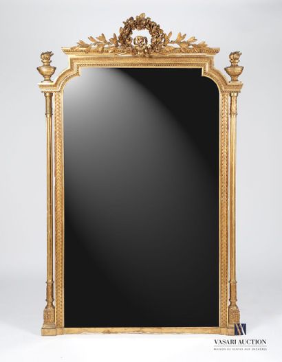 null Wooden mantel mirror and stucco molded, carved and gilded, the beveled glass...
