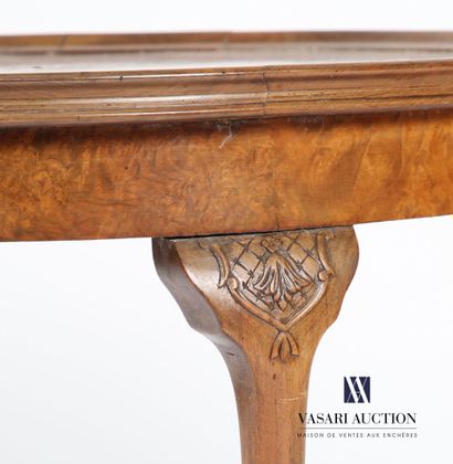 null Pedestal table in walnut and walnut veneer, the round top rests on four cambered...