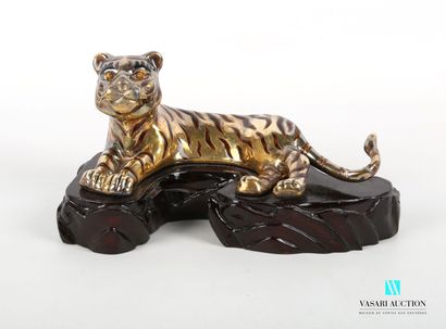 null CHINA
Gilt and enamel subject representing a tiger lying on a wooden base. 
Marked...