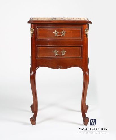 null Pair of bedside tables in molded and carved mahogany, the top of rectangular...