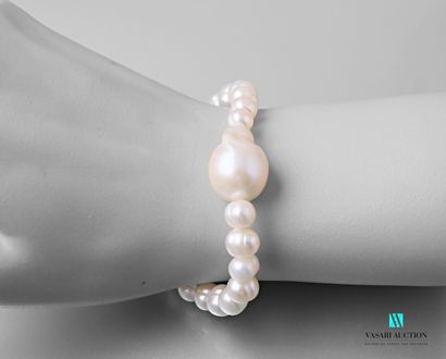 null Bracelet on stretch cord decorated with freshwater cultured pearls and a central...