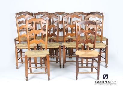 null Suite of eleven chairs in natural wood, the back threefold openwork, the seat...