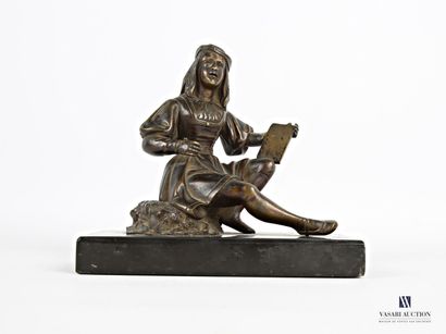 null Bronze subject with brown patina representing a young painter crunching on a...