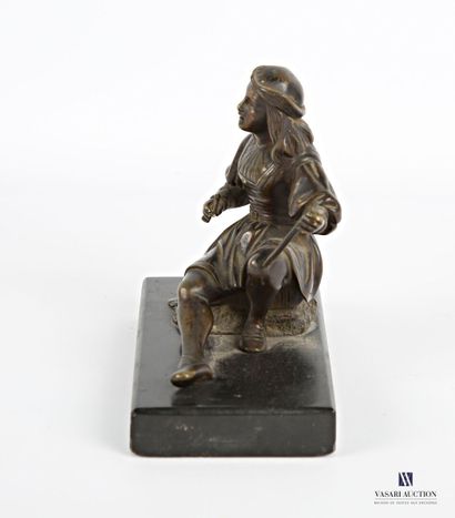 null Bronze subject with brown patina representing a young painter crunching on a...