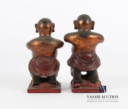 null Two subjects in red lacquered wood with gold highlights, representing men on...