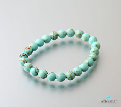 null Bracelet decorated with turquoise beads on elastic cord.