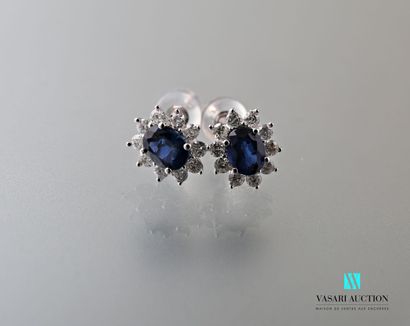 null Pair of oval-shaped white gold earrings set with two oval-cut sapphires calibrating...