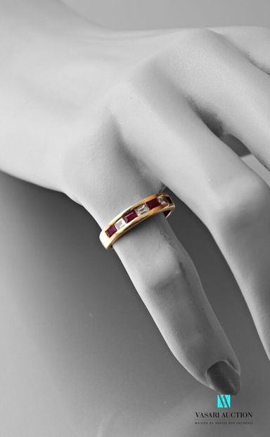 null Yellow gold ring set with three baguette diamonds of about 0.05 carat alternating...