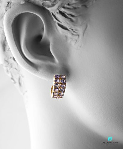 null Pair of silver earrings adorned with two lines of oval-cut tanzanites, the clasps...