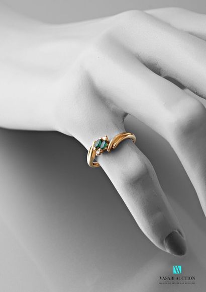 null Yellow gold ring 750 thousandth set with two emeralds navette size and small...