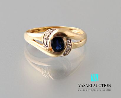null Yellow gold ring 750 thousandth set with an oval sapphire between two small...