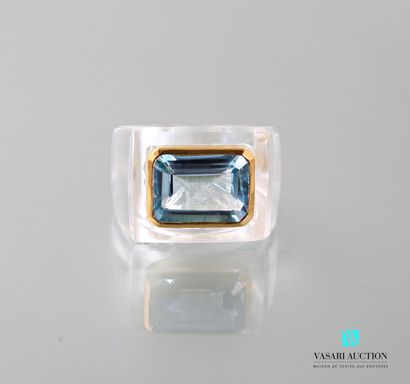 null Ring set with a rectangular blue topaz with cut sides in a closed setting in...