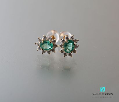 null Pair of yellow gold oval earrings set with two oval emeralds calibrating a total...