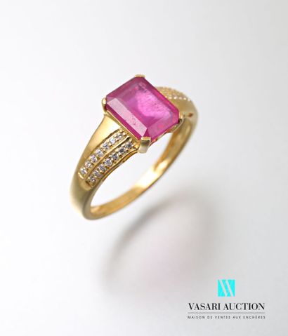 null A vermeil ring set with an emerald-cut ruby and two lines of diamonds.
Gross...
