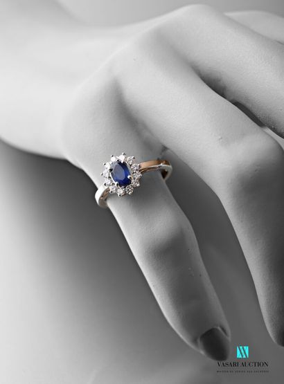 null Daisy ring in white gold 750 thousandth set in its center with an oval sapphire...