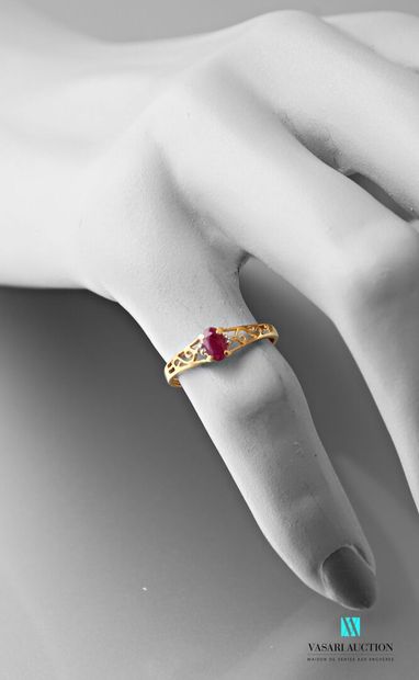 null Yellow gold ring 750 thousandth set with an oval ruby with two small diamonds...