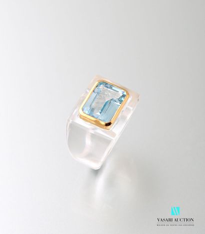 null Ring set with a rectangular blue topaz with cut sides in a closed setting in...