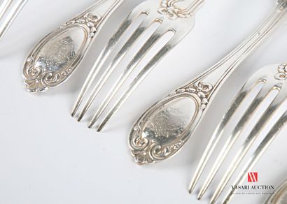 null Suite of nine silver forks, the handle hemmed with nets is finished by a medallion...