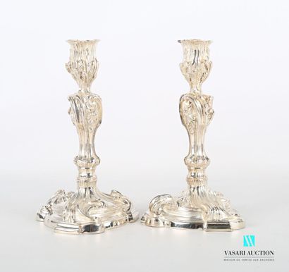 null Pair of silver torches posing on a round base cut out decorated with broad leaves...